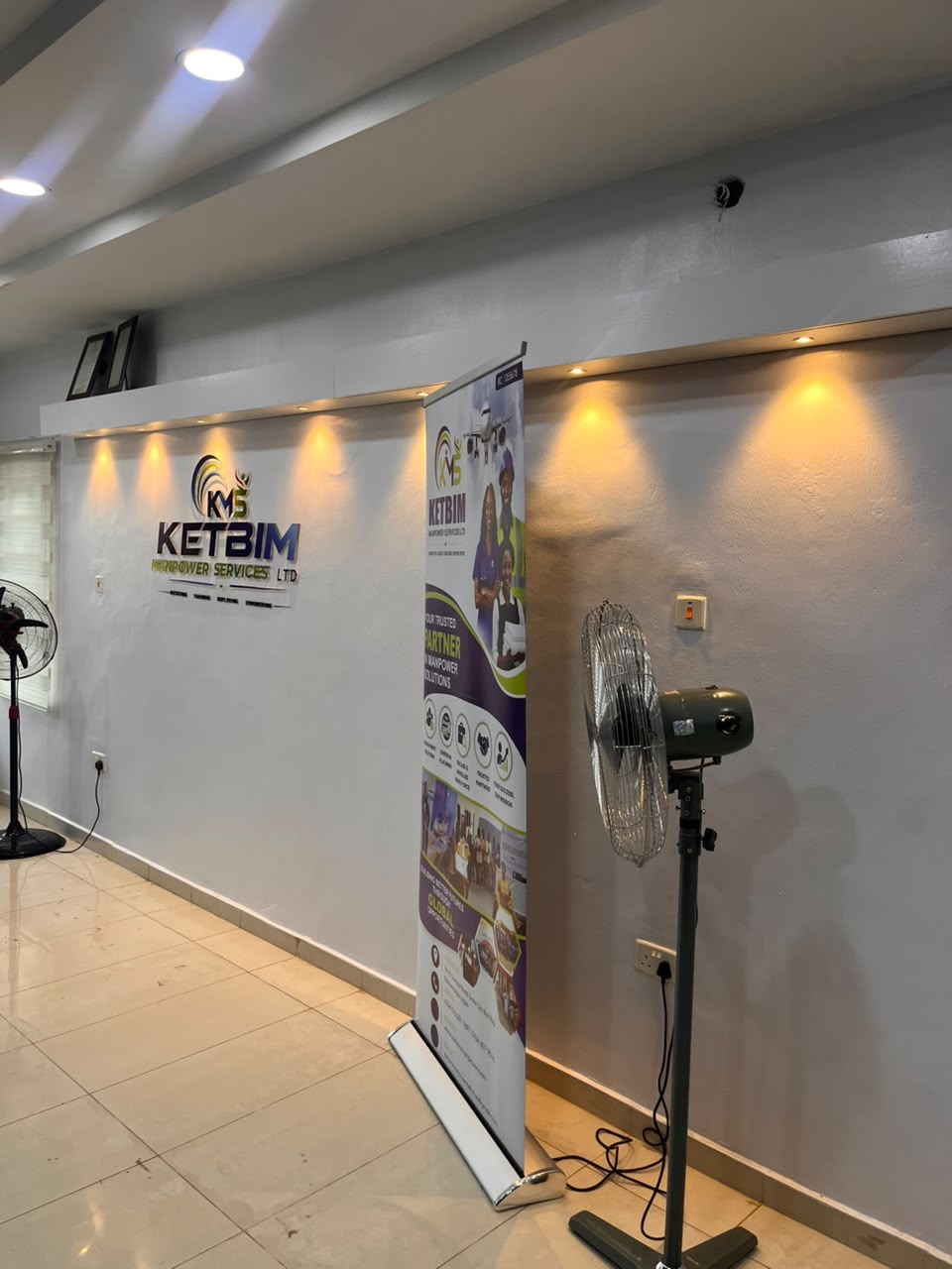 KETBIM logo wall with a roll-up banner along the reception corridor