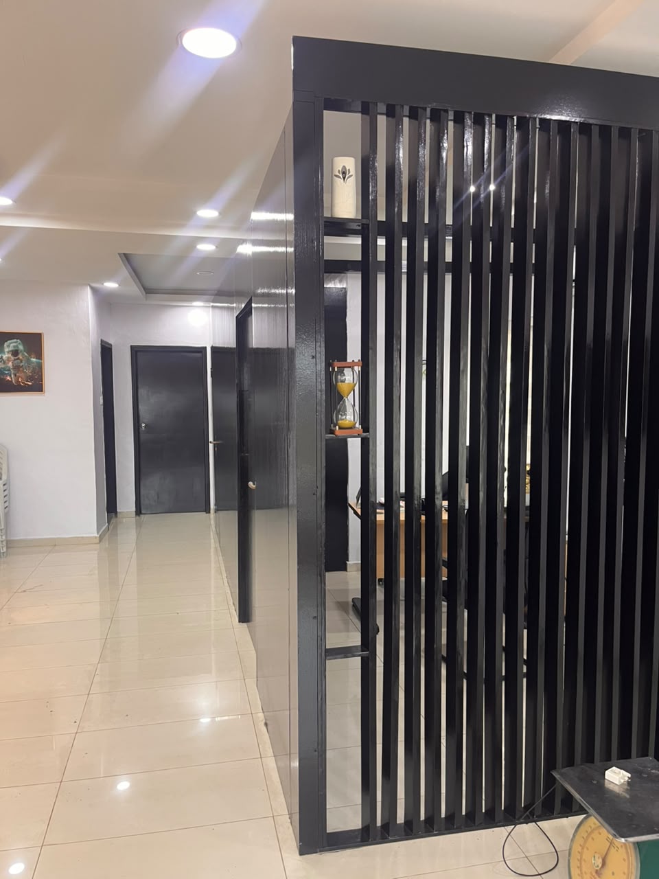 Office corridor with doors and the slatted divider along the reception floor
