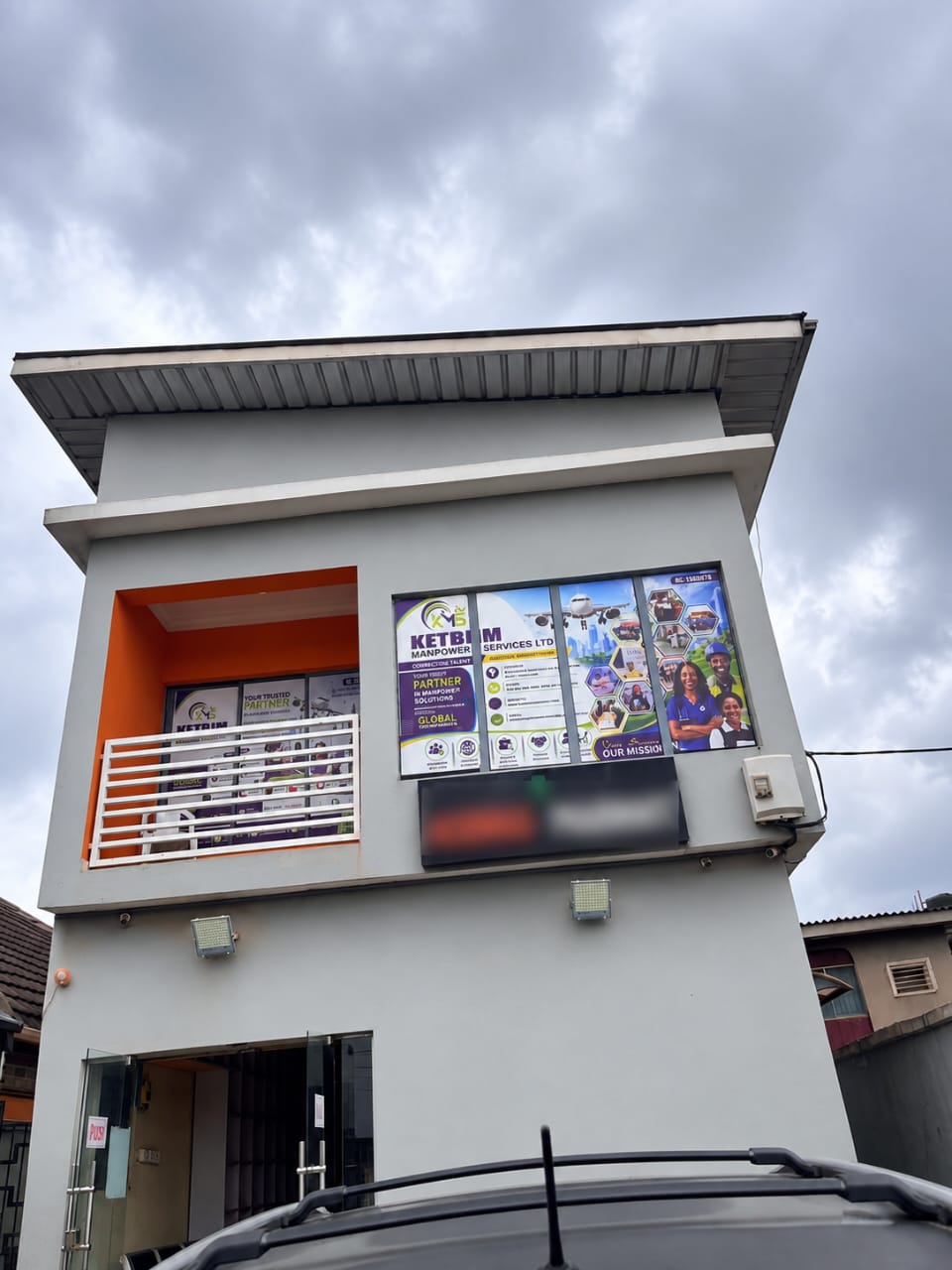 Exterior of the KETBIM office building with branded window banners